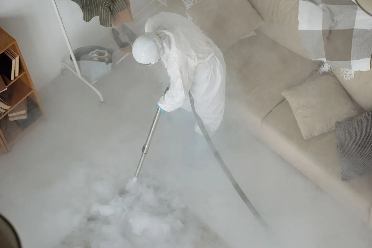 Biohazard cleanup technician in protective equipment, Covington, TN